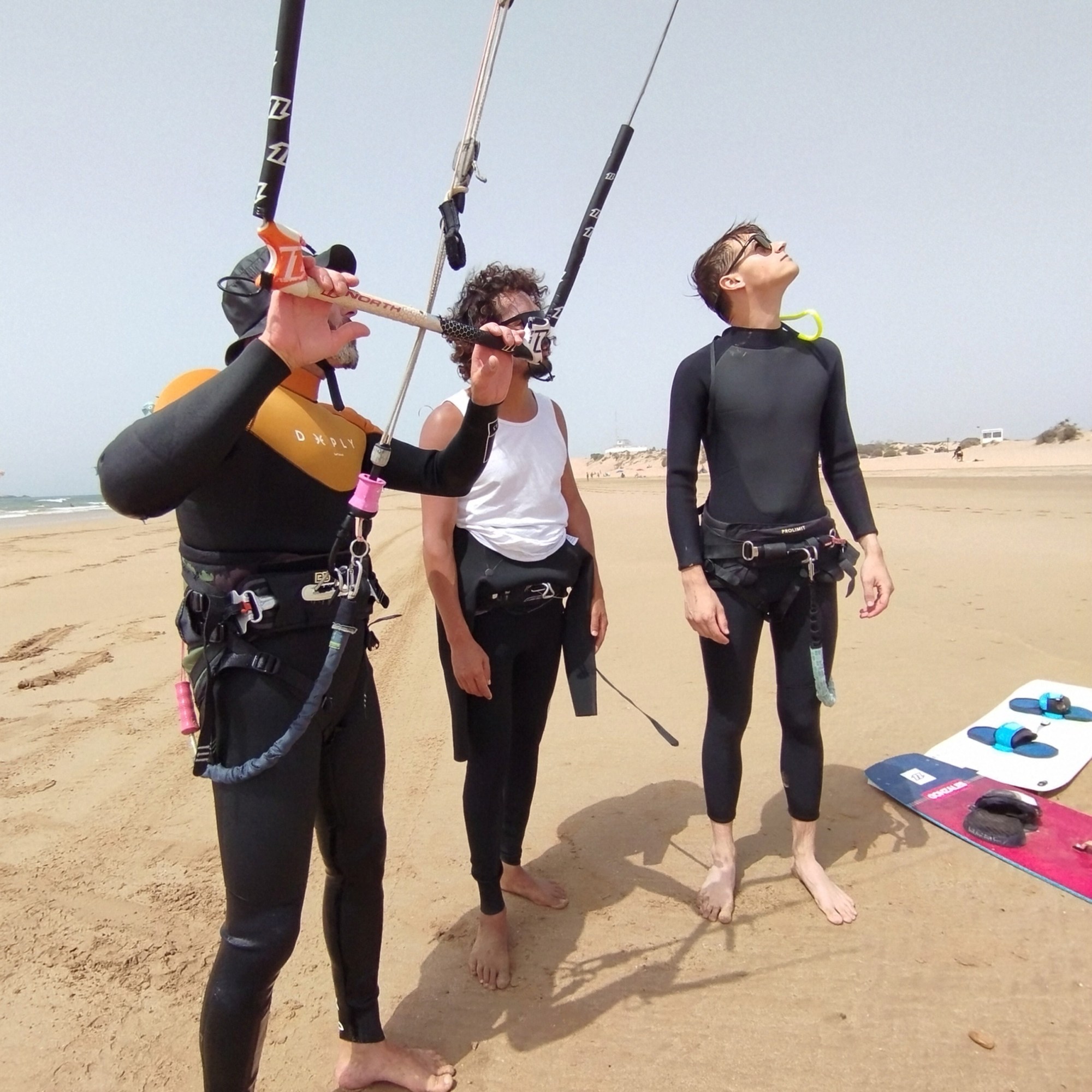 Kitesurfing student learning kite control on beach with instructor guidance
